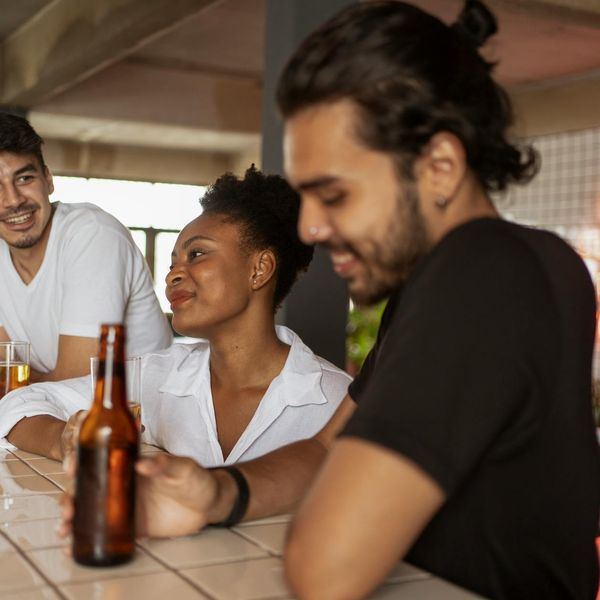 Diverse group of people smiling during a light stretching session.
